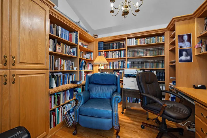Built-in wood-finish cabinetry and shelving with traditional hardware