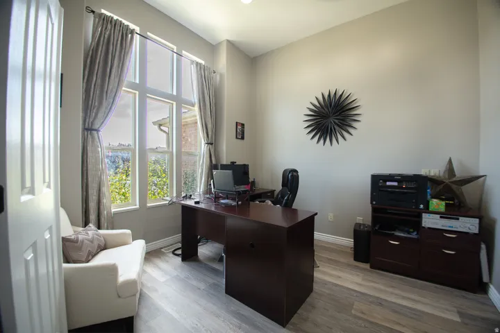Tall ceilings, wood-finish flooring, and expansive windows