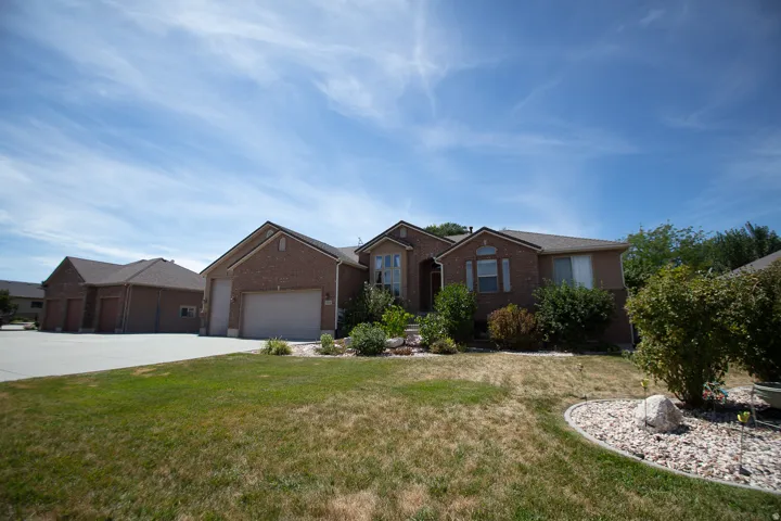 Brick exterior with attached two-car garage and additional detached two-car garage