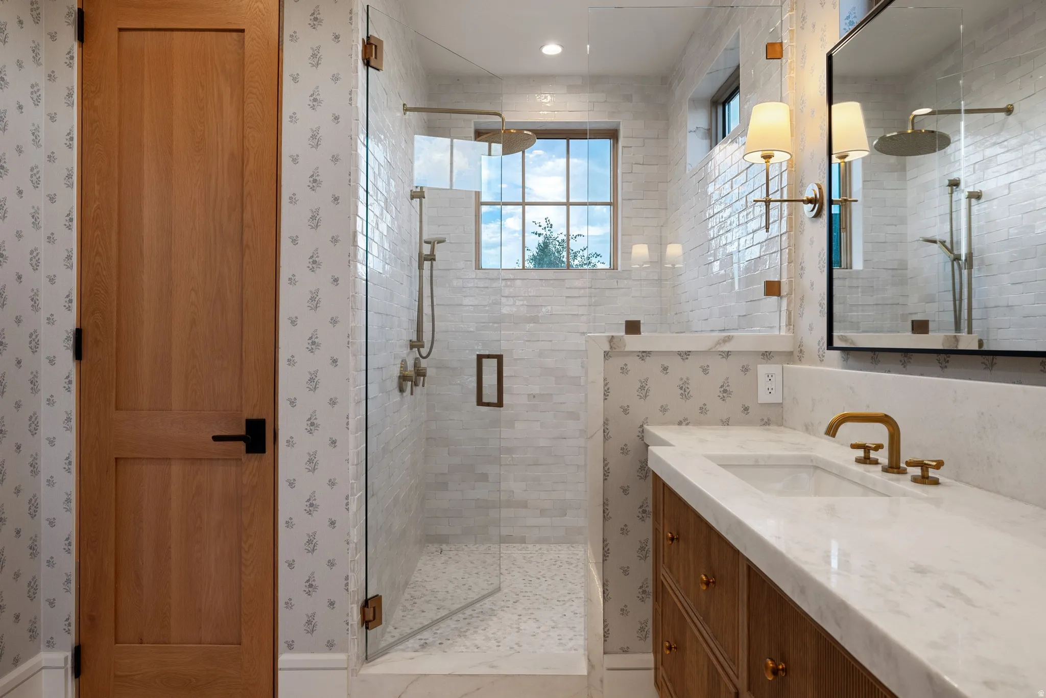 Glass-enclosed shower with subway tile, window, and rain showerhead