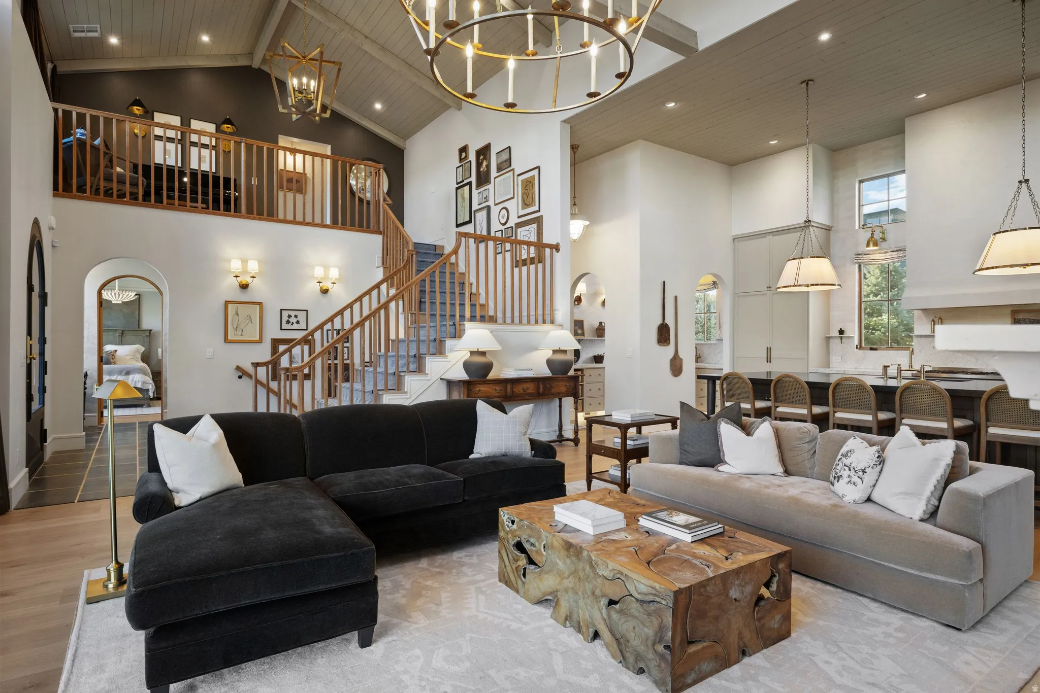 Soaring two-story great room anchored by a wood-burning fireplace and accented with recessed ceiling lighting and a decorative pendant fixture