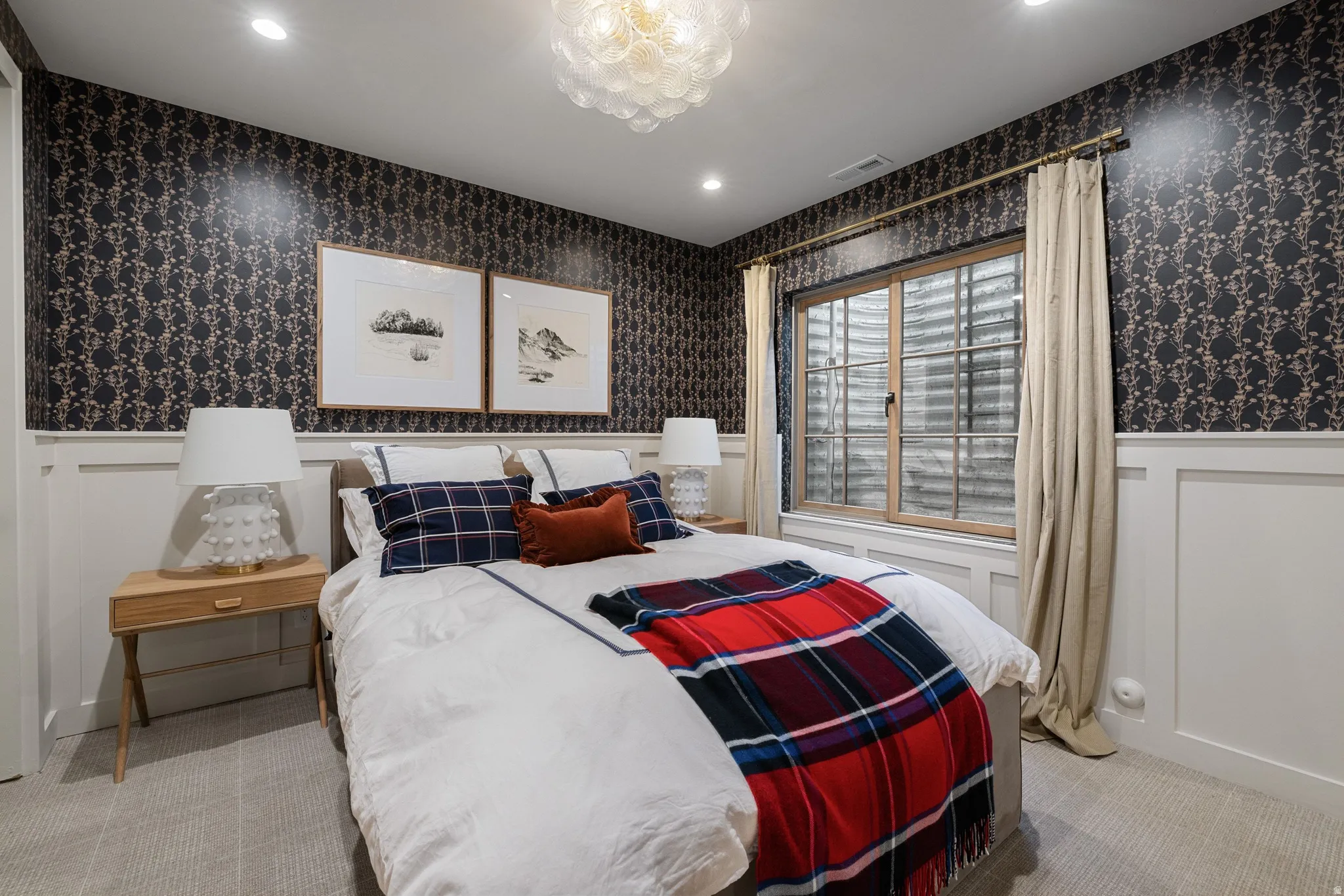 Recessed lighting, decorative ceiling fixture, patterned wallpaper, white wainscoting, and a window with a wood frame