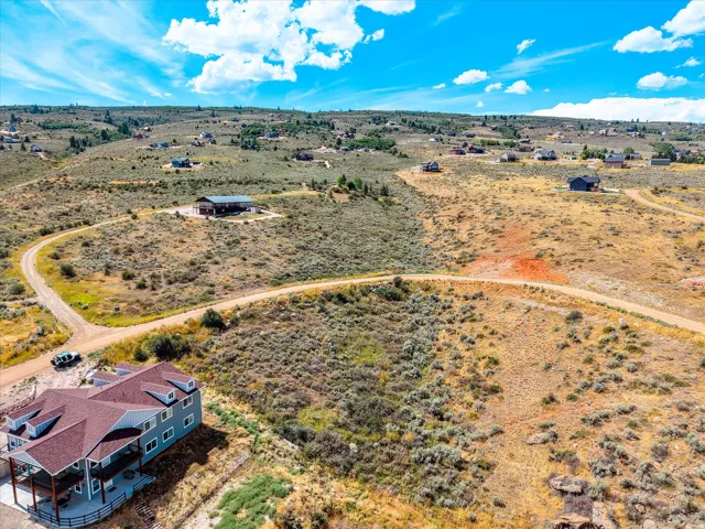 Expansive rural property featuring a contemporary residence with modern architectural lines, situated on substantial acreage with mature native vegetation and established landscaping