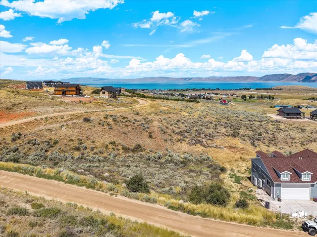 Expansive hilltop setting with panoramic vistas overlooking blue water and distant mountain ranges