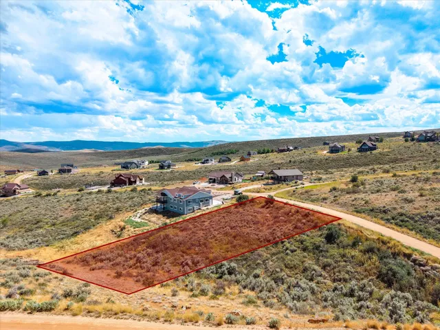 Expansive vacant land offering approximately 5+ acres of cleared, level terrain with prepared foundation area