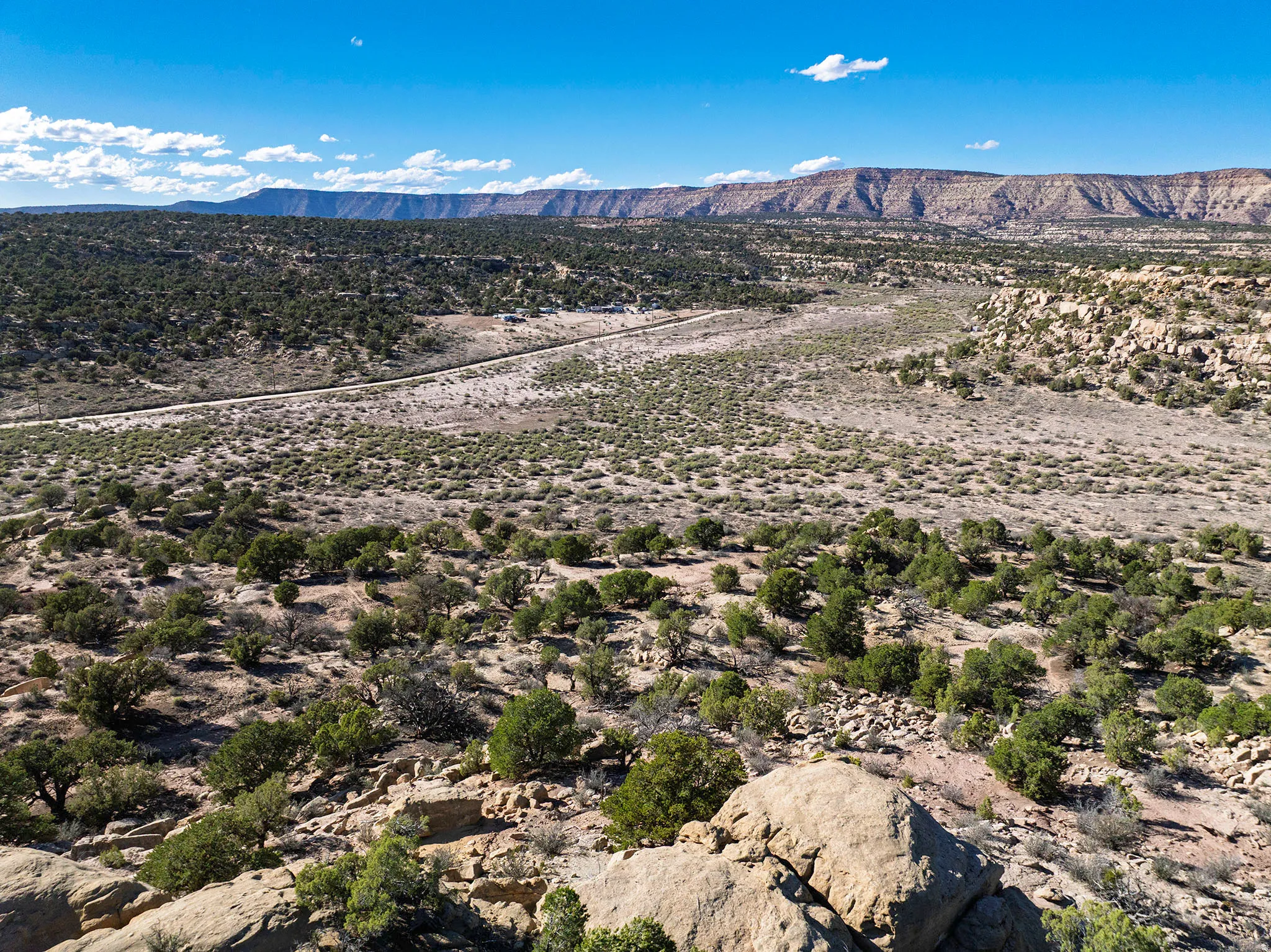 Expansive desert landscape featuring rugged terrain and distant mountain ranges