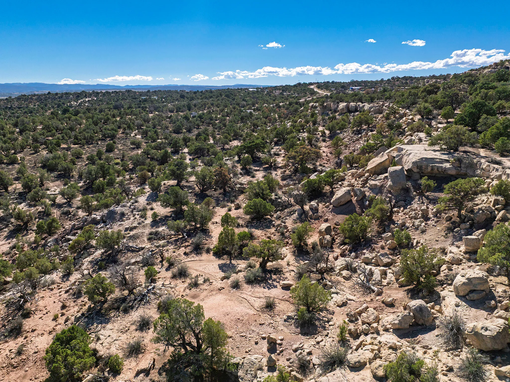 Expansive desert landscape featuring natural rock formations and abundant native vegetation