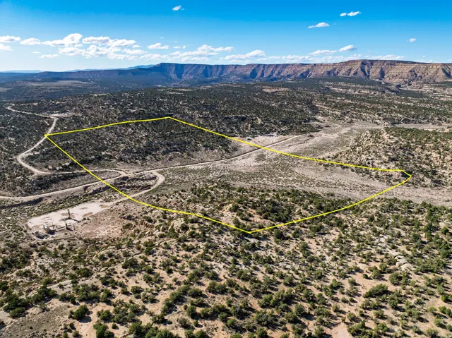 Expansive desert landscape featuring rugged terrain and distant mesas
