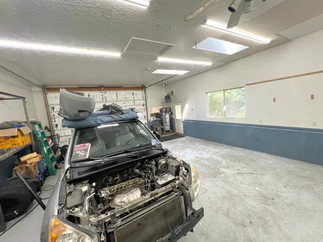 Concrete flooring with painted walls, overhead fluorescent lighting, and a window providing natural light