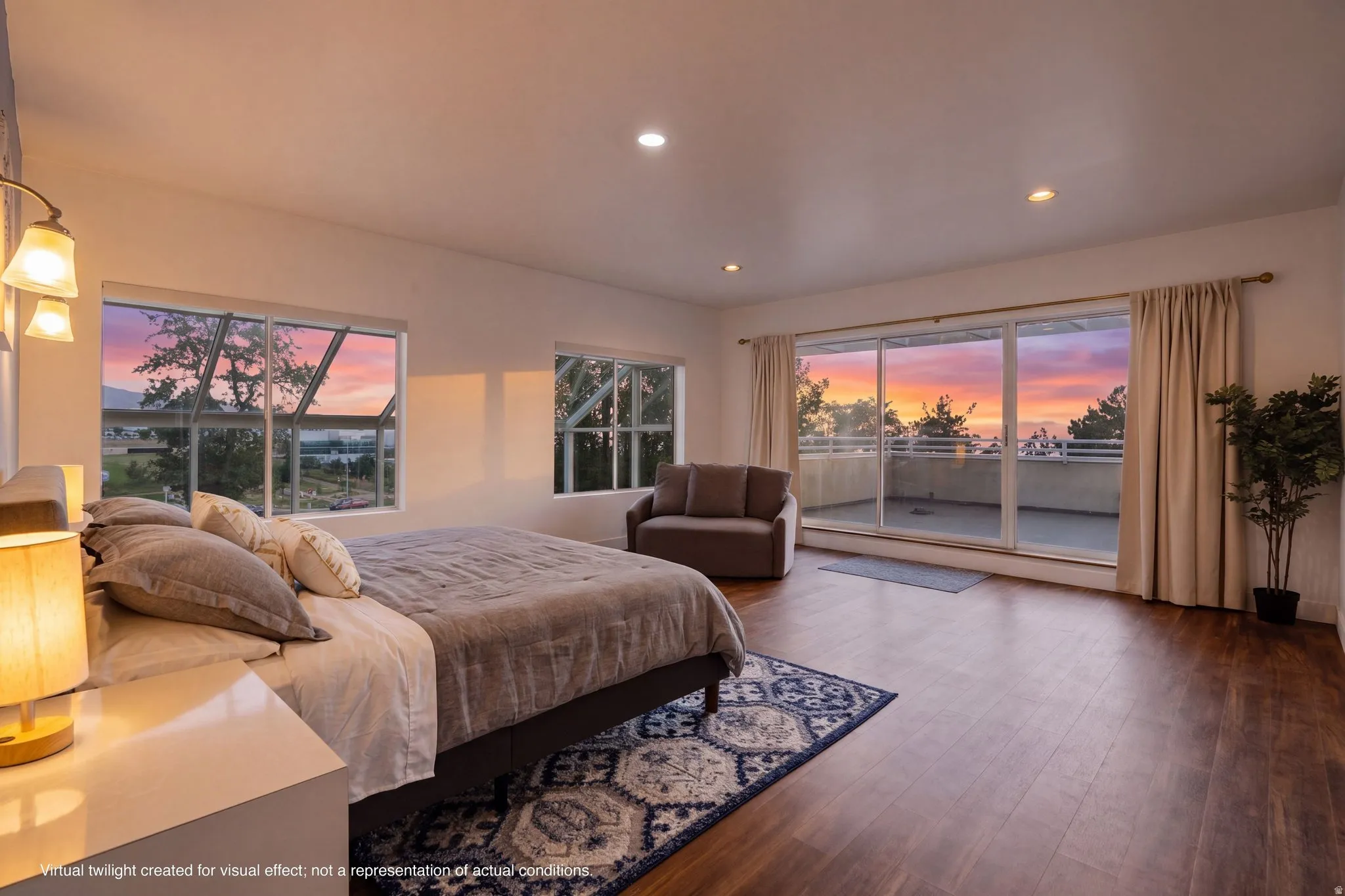 Spacious interior with wood-finish flooring, recessed lighting, and a private balcony