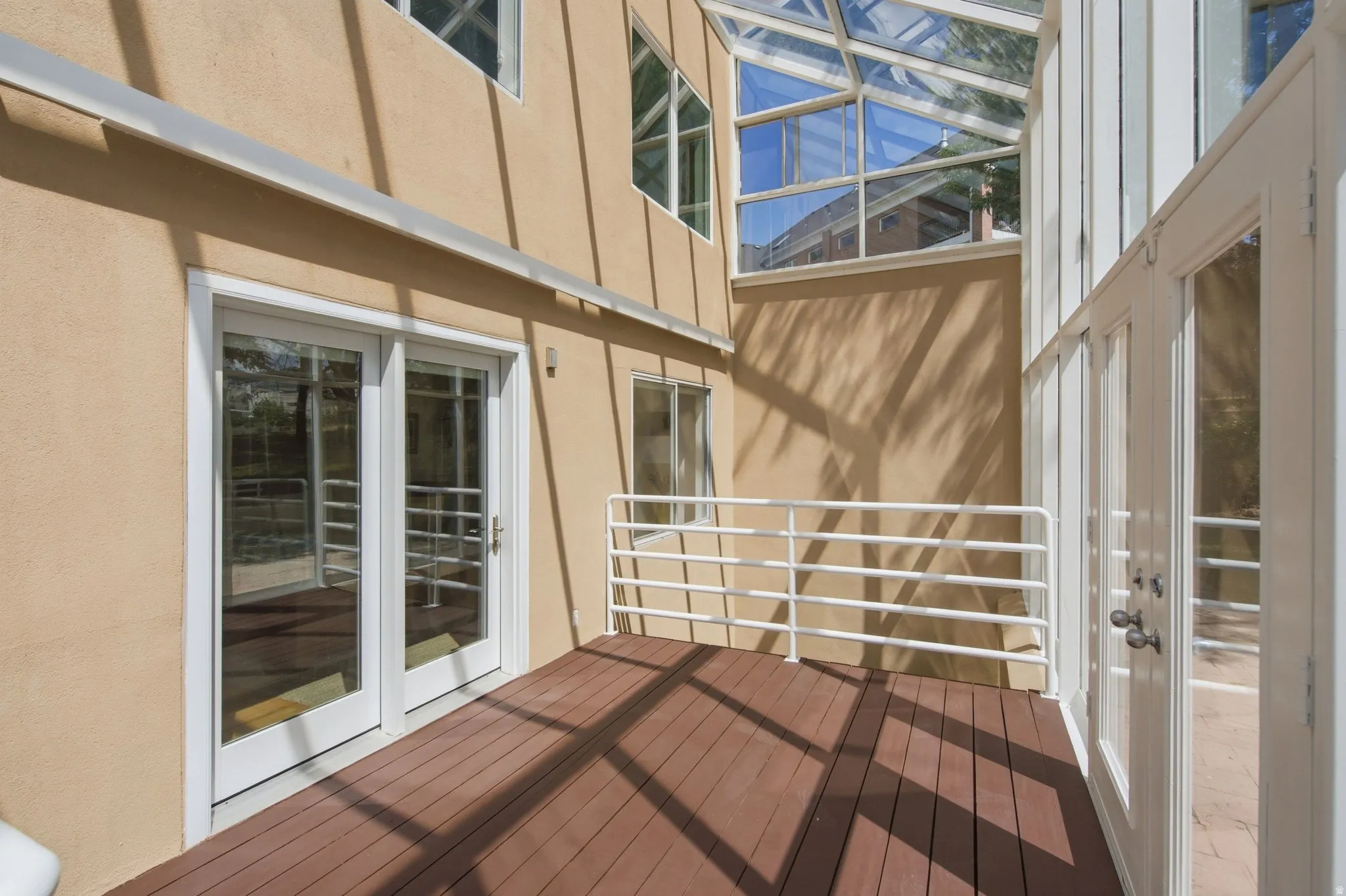 Sunlit outdoor deck with wood-finish flooring