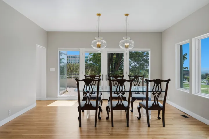 Hardwood flooring, dual pendant light fixtures, and multiple windows
