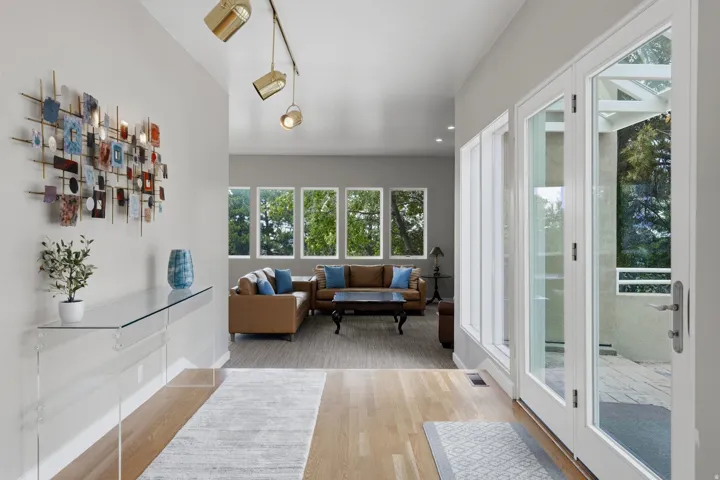 Hardwood flooring, recessed lighting, track lighting, white trim, glass-paneled entry door