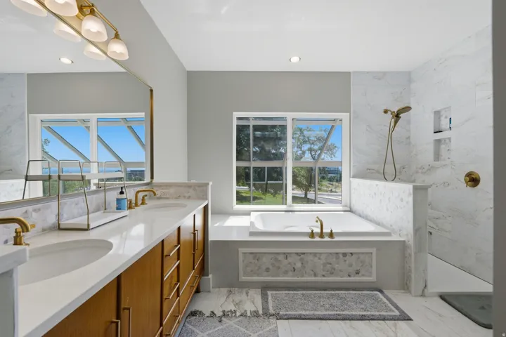 Dual vanity with integrated sinks and brass-finish fixtures