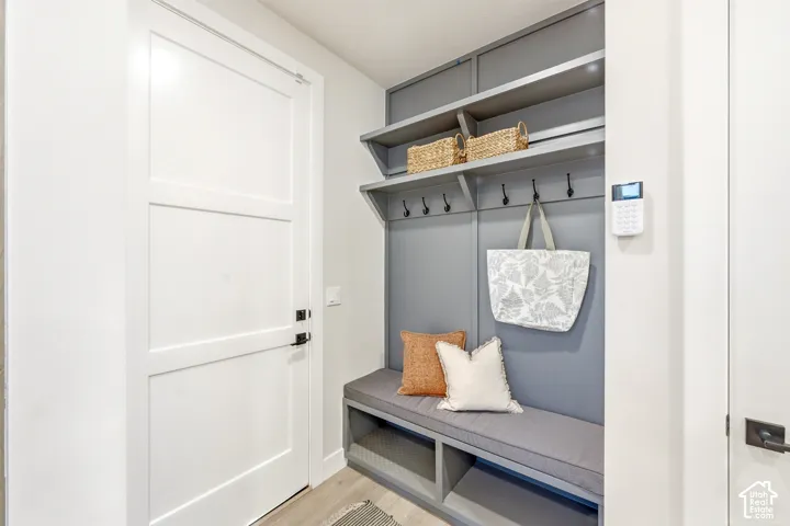 Built-in mudroom bench with integrated shelving, storage, and wall-mounted hooks