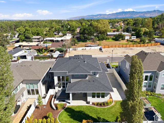 Modern two-story residence with a multi-gabled roofline and a well-maintained lawn