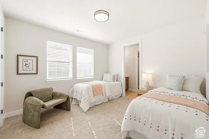 Recessed lighting, two windows with blinds, light-toned carpet flooring, and a white ceiling