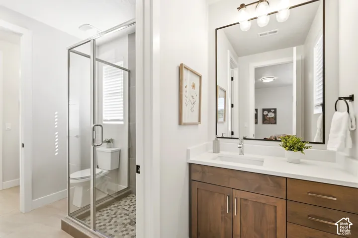 Custom wood-finish vanity with a white countertop and rectangular undermount sink
