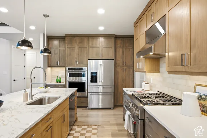Stainless steel appliance suite, including a double oven and refrigerator