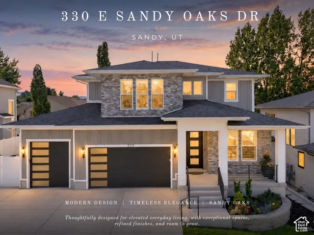 Contemporary exterior featuring stone accents, a covered entry, and a two-car garage with modern doors