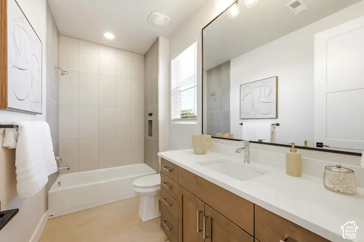 Wood-finish vanity with a rectangular undermount sink, white countertop, and chrome faucet