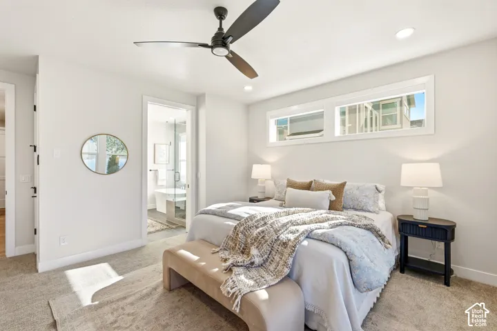 Carpeted flooring, recessed lighting, ceiling fan, transom windows, and an attached bathroom with a glass-enclosed shower