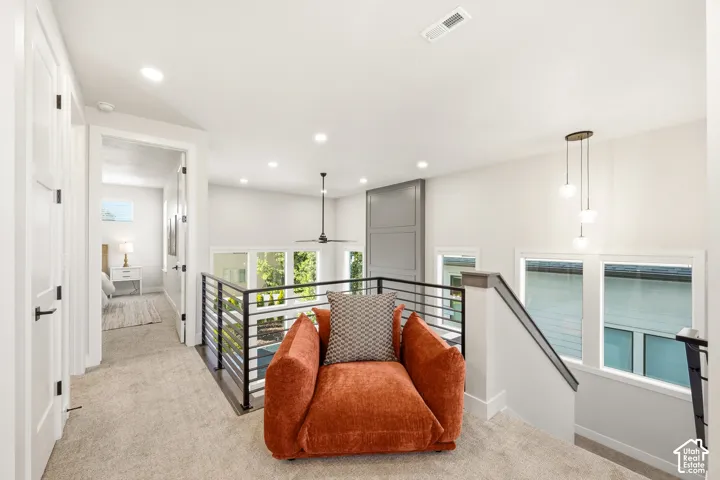 Carpeted upper level with recessed lighting, a modern ceiling fan, and a contemporary pendant light fixture
