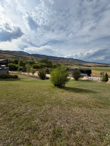 Expansive green space with distant mountain scenery