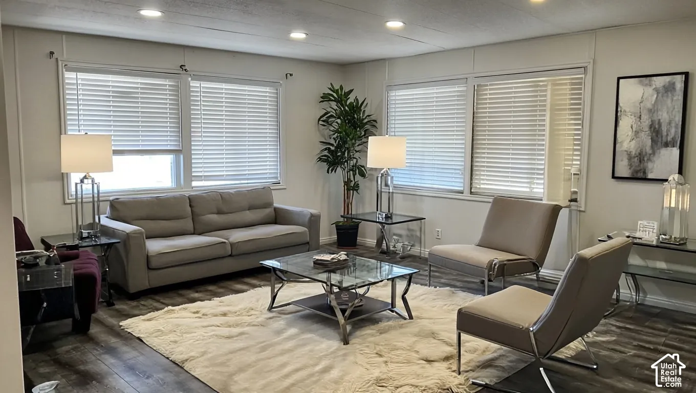 Recessed lighting, wood-finish flooring, and multiple windows with blinds