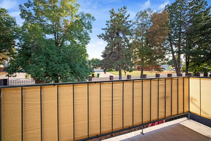 Balcony with a black metal railing and privacy screening
