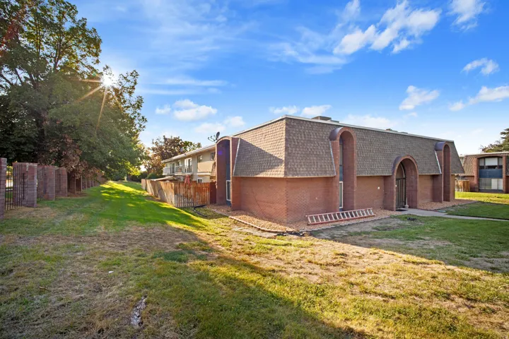 Brick exterior with a gambrel roof and arched entryway