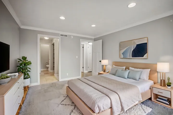 Recessed lighting, crown molding, light-toned walls, and wood-finish flooring