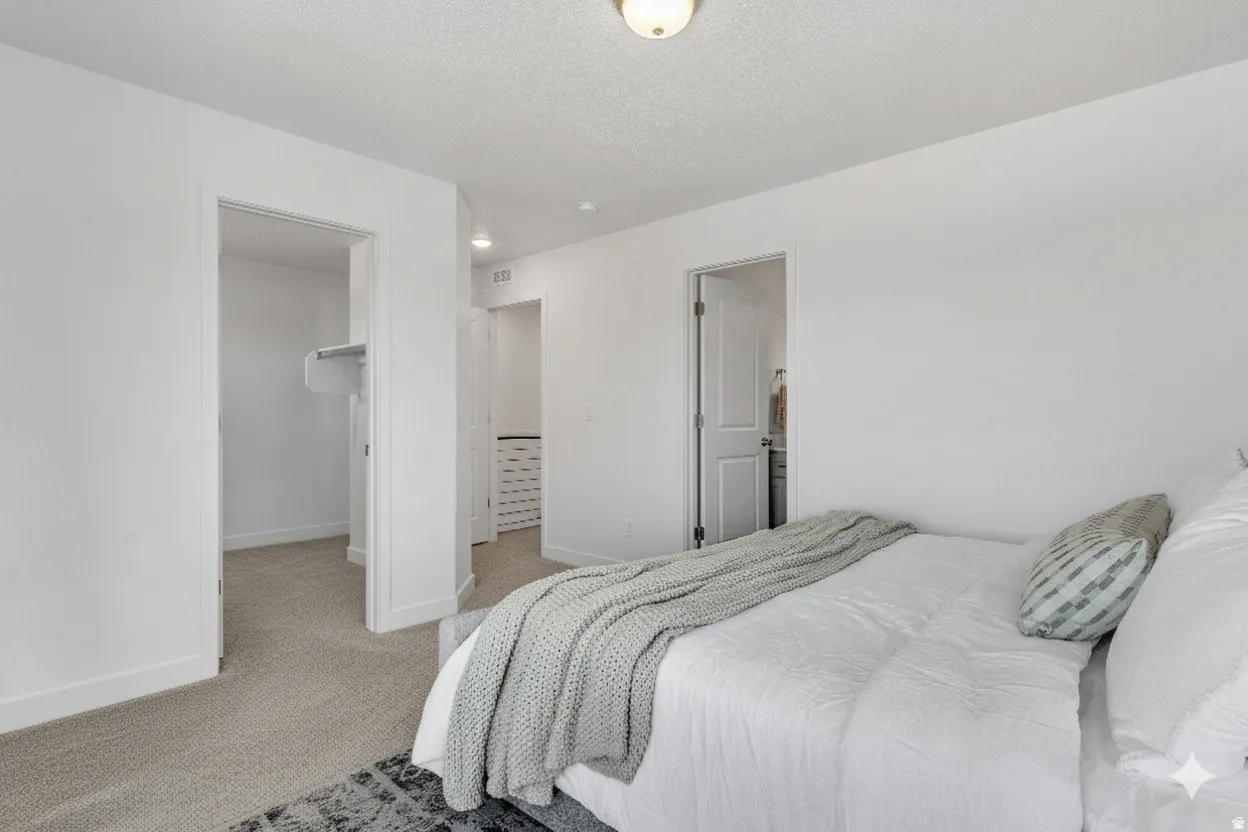 White walls, carpeted flooring, and a flush-mount ceiling light