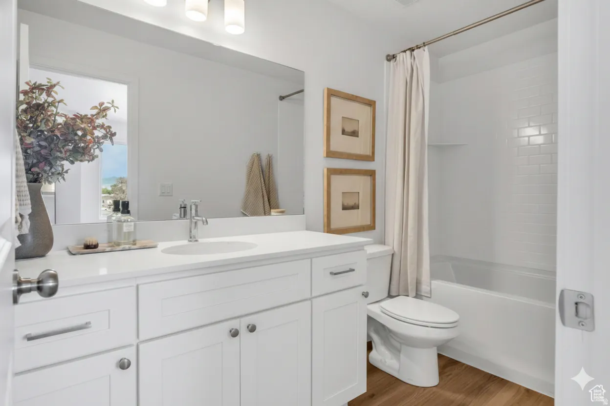 Bright, spa-inspired bathroom featuring a white vanity with dual sinks, quartz countertop, and chrome hardware