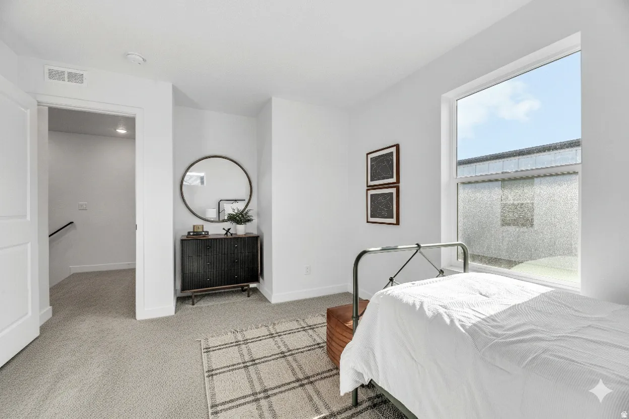 Wall-to-wall carpeting with natural light from a large window