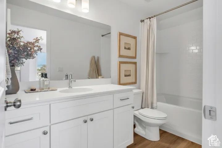 Bright, spa-inspired bathroom featuring a white vanity with dual sinks, quartz countertop, and chrome hardware