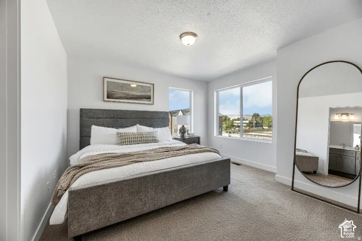 Recessed lighting and multiple windows illuminate this interior space