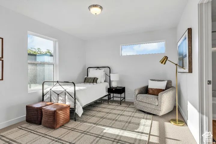 Recessed lighting, large window with ample natural light, additional transom window, light-colored carpeting, white walls