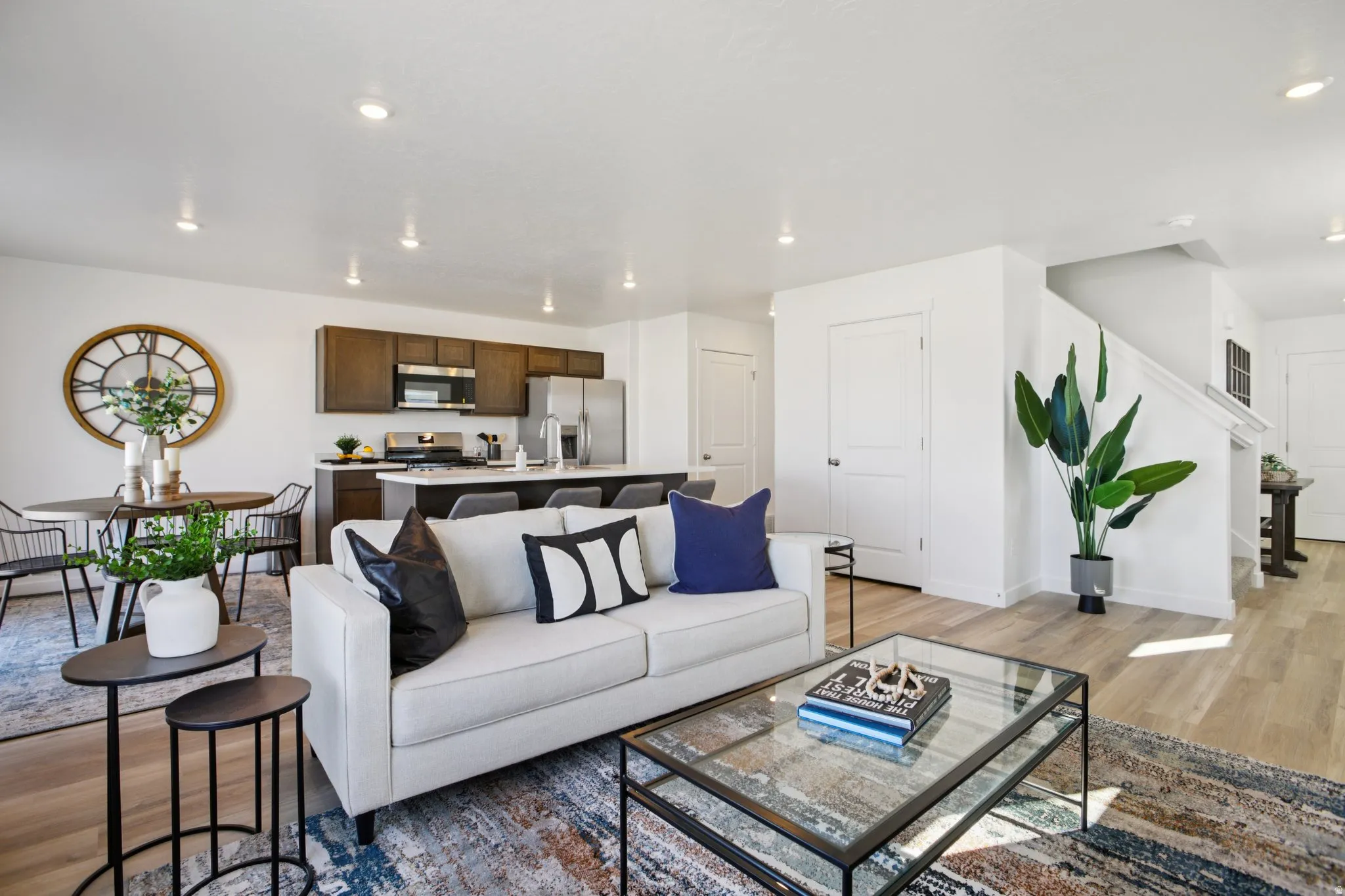 Open-concept living space featuring wood-finish flooring and recessed lighting