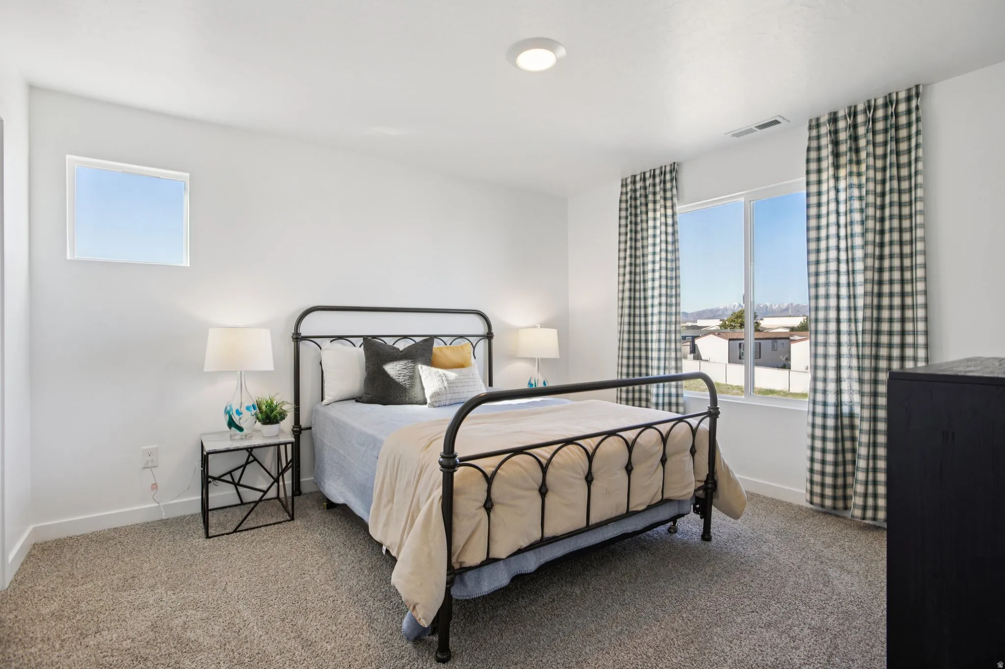 Recessed lighting, light-toned carpeting, and multiple windows