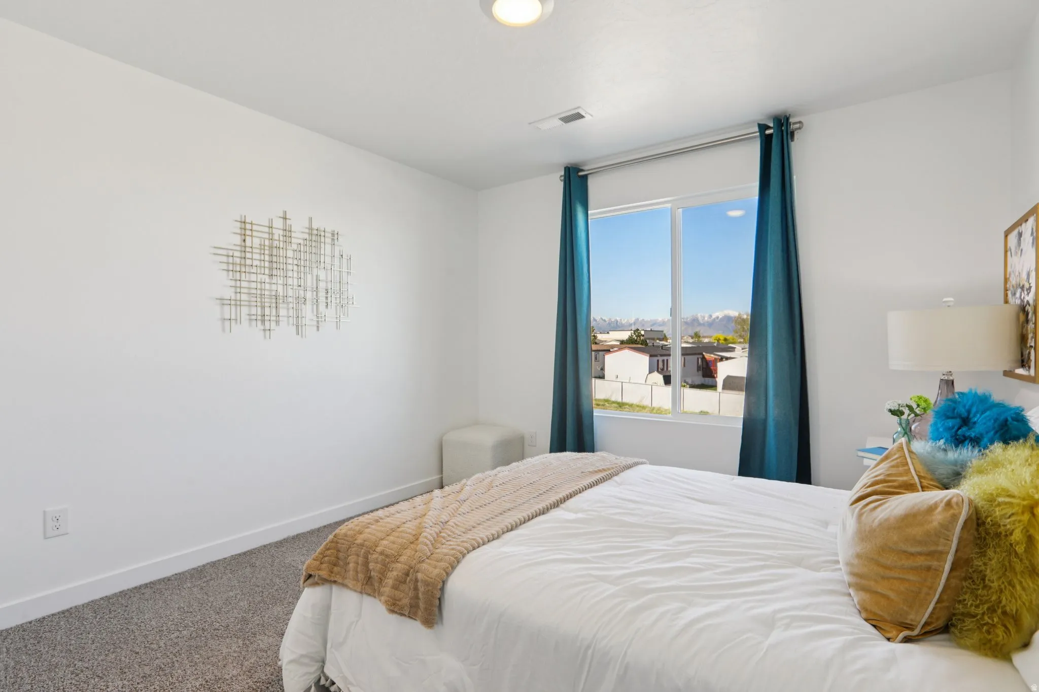 Bright room featuring a large window, wall-to-wall carpeting, and a flush-mount ceiling light fixture