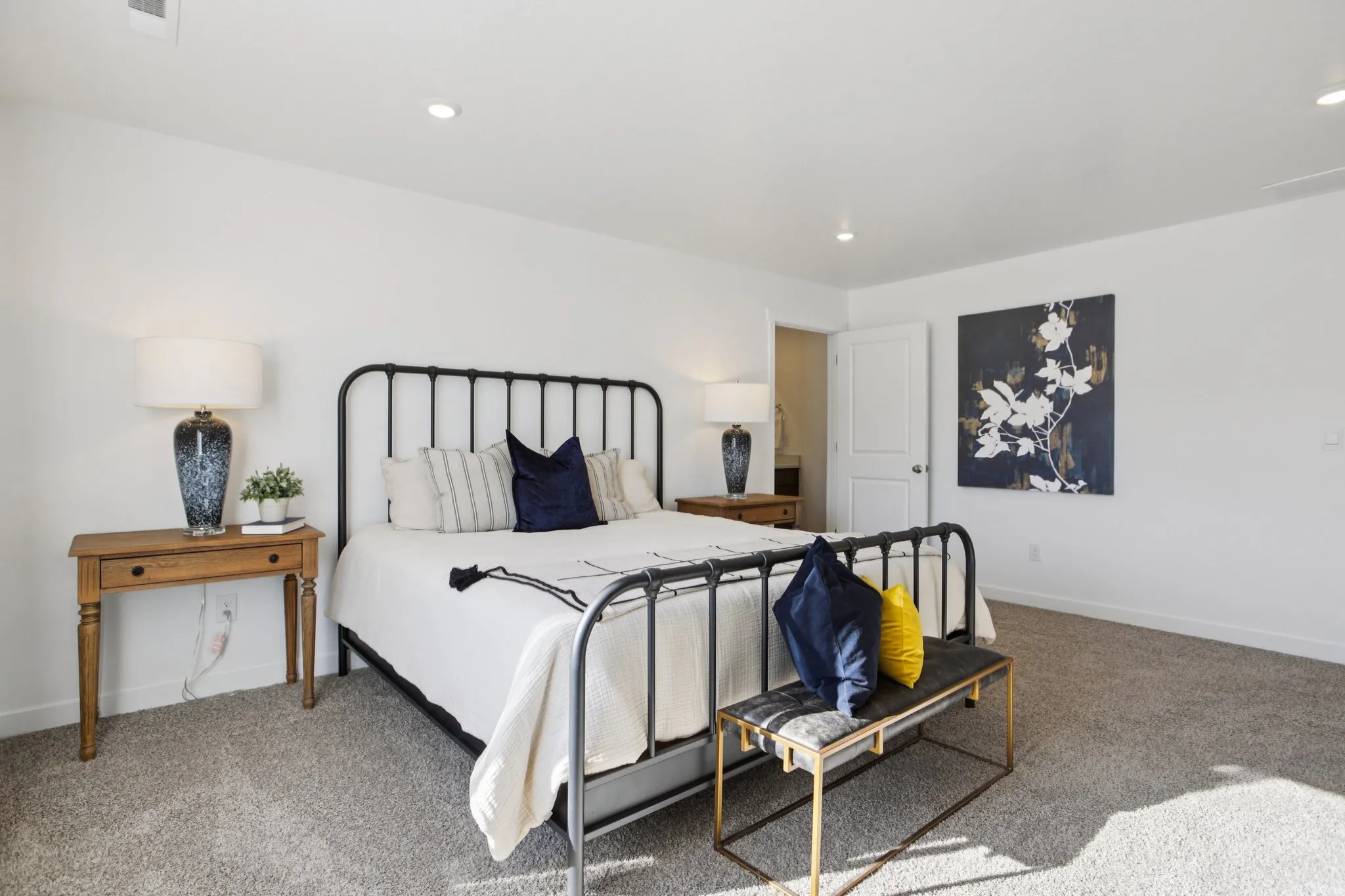 Recessed lighting, light gray carpeting, and white walls