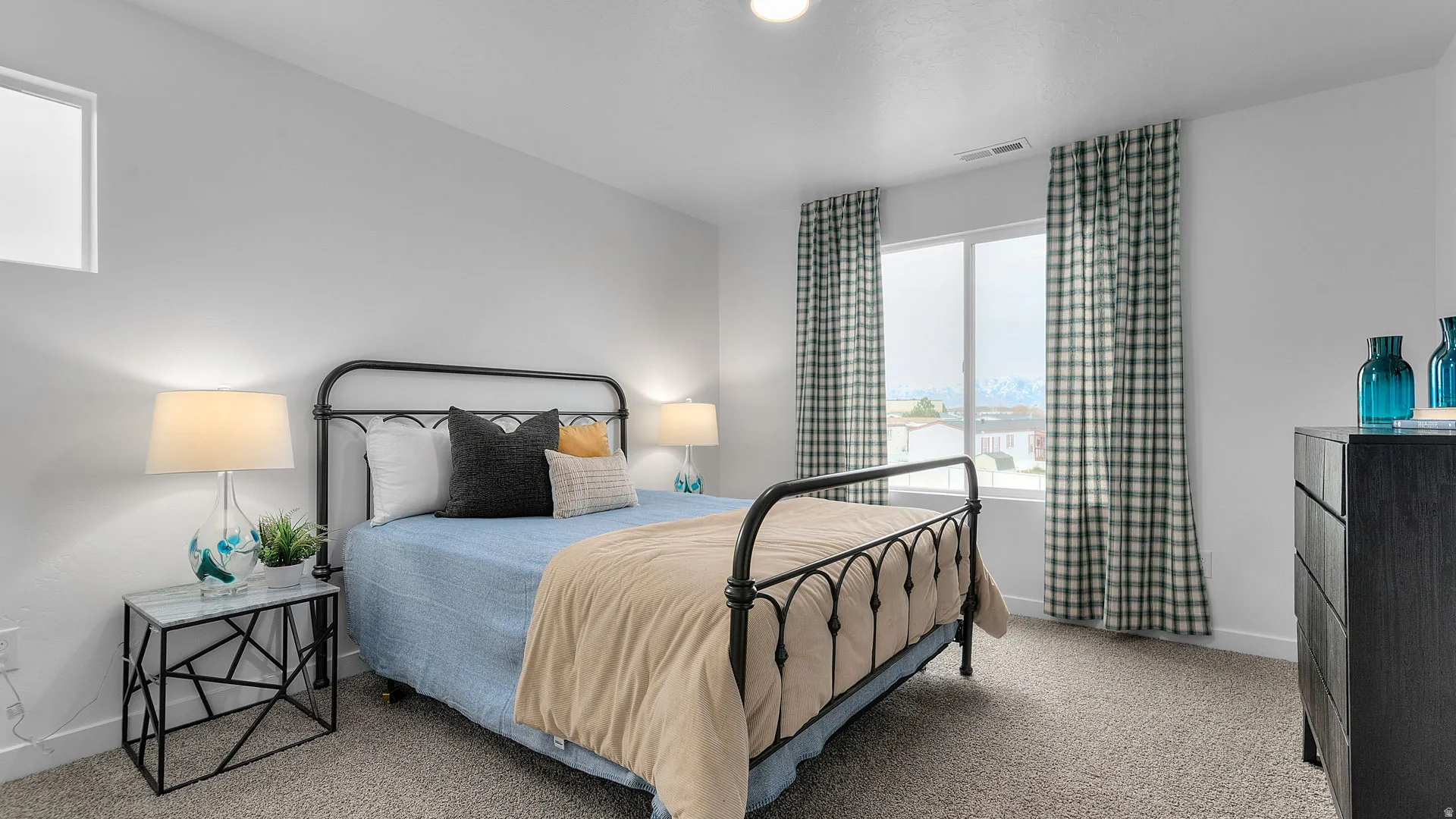 Bright interior with neutral wall paint, a large window, recessed lighting, and carpeted flooring