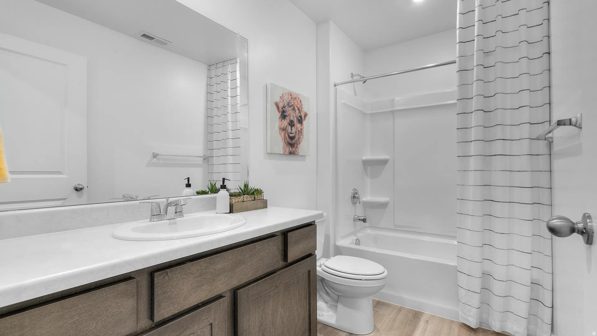 White vanity featuring a single-bowl sink and chrome faucet