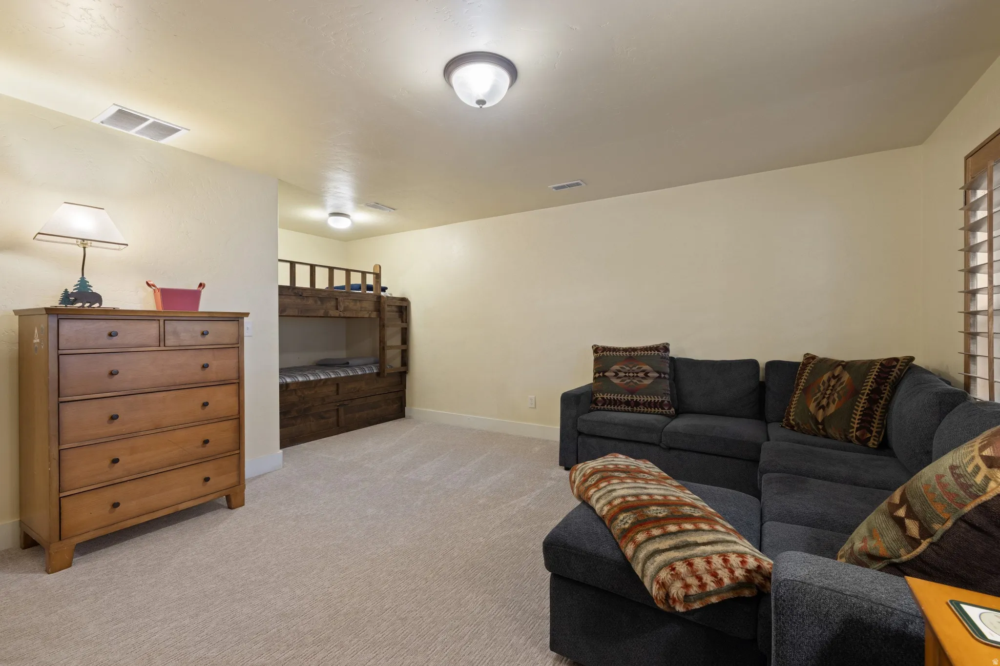 Spacious recreation room featuring neutral carpeting, recessed ceiling lighting, and ample square footage for flexible use