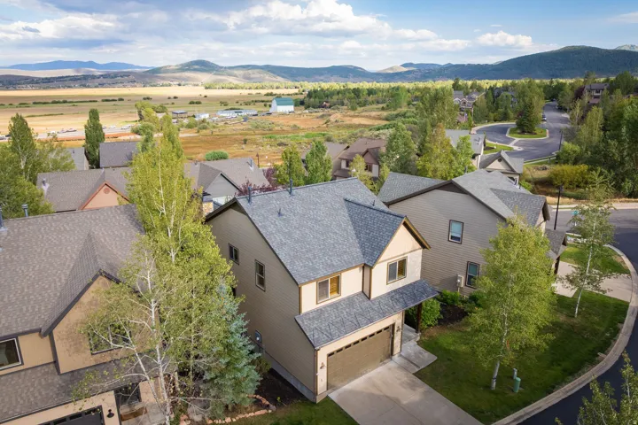 Modern two-story residence featuring a composite shingle roof, two-car garage, and contemporary architectural design