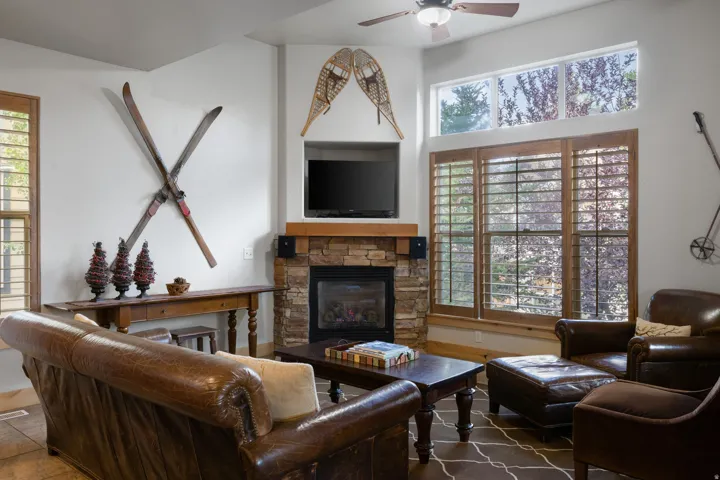 Corner fireplace with a stone surround and wood mantel