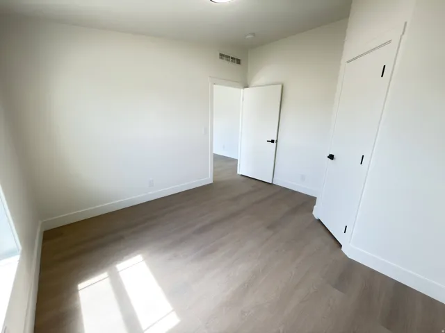 Wood-finish flooring, white walls, and white trim
