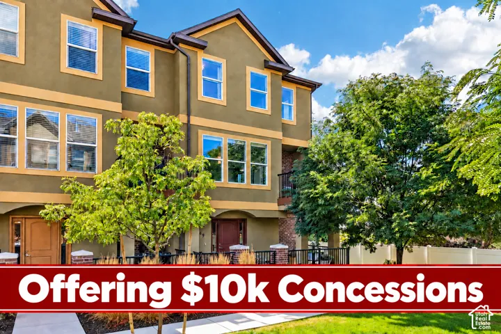 Multilevel exterior with stucco and brick accents, featuring multiple windows and a private balcony