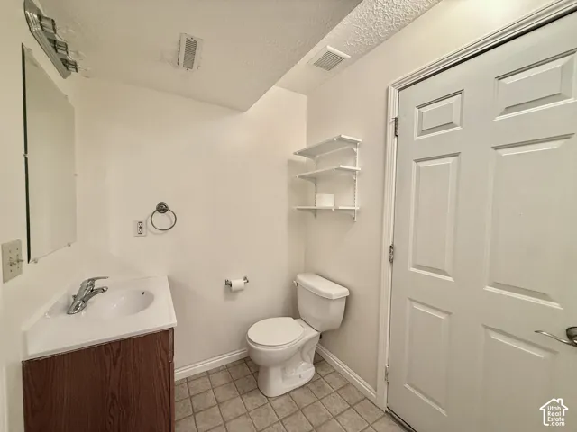 Wood-finish vanity with an integrated sink, polished chrome faucet, and mirrored medicine cabinet